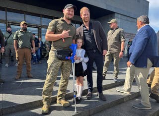 Britain's Prince Harry poses for a picture with wounded Ukrainian serviceman Vasyl